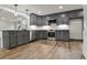 Modern kitchen featuring gray cabinets, stainless steel appliances, and granite countertops at 2923 Glenhaven Sw Ct, Conyers, GA 30094