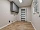 Well-lit laundry room with built-in shelves and ample space for appliances at 2923 Glenhaven Sw Ct, Conyers, GA 30094