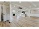 Open-concept living room featuring a fireplace, kitchen access, and light wood flooring at 2923 Glenhaven Sw Ct, Conyers, GA 30094