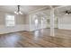 Open-concept living room featuring wood-look flooring, wainscoting, and bright lighting at 2923 Glenhaven Sw Ct, Conyers, GA 30094