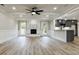 Bright living room with a fireplace, modern fan, open to the kitchen, and natural light at 2923 Glenhaven Sw Ct, Conyers, GA 30094
