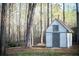 Charming shed nestled among mature trees offering additional storage space at 2923 Glenhaven Sw Ct, Conyers, GA 30094