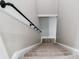 Carpeted staircase with black iron pipe handrail at 2923 Glenhaven Sw Ct, Conyers, GA 30094