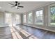 Sunroom featuring wood-look floors, beadboard walls, many windows and a ceiling fan at 2923 Glenhaven Sw Ct, Conyers, GA 30094