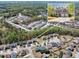 Aerial view showcasing a residential area with lush trees and well-maintained homes, offering a serene environment at 3285 Pebble Ridge Ln, Buford, GA 30519