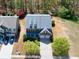 An aerial view of a two-story home with a well-manicured lawn, mature trees, and a two-car garage at 3285 Pebble Ridge Ln, Buford, GA 30519
