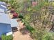 Aerial view showing a covered patio, a lush backyard, and mature trees behind the house at 3285 Pebble Ridge Ln, Buford, GA 30519