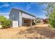 A spacious backyard with a covered patio, outdoor seating, storage shed and lush greenery at 3285 Pebble Ridge Ln, Buford, GA 30519