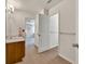 Bathroom with a wood vanity, framed mirror, and doorway view into a bedroom at 3285 Pebble Ridge Ln, Buford, GA 30519