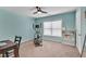 Bright bedroom features an elliptical machine, window, ceiling fan, and built-in shelving at 3285 Pebble Ridge Ln, Buford, GA 30519