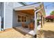 Covered patio with wood ceiling, ceiling fans, outdoor seating and stone pavers overlooks yard at 3285 Pebble Ridge Ln, Buford, GA 30519
