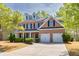 Charming two-story brick home with a well-manicured lawn and a two-car garage at 3285 Pebble Ridge Ln, Buford, GA 30519