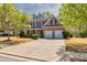 Beautiful two-story home with brick facade, attached two-car garage, and well-maintained front yard at 3285 Pebble Ridge Ln, Buford, GA 30519