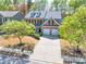 Charming two-story home with brick and siding, dormer windows and a well-manicured front lawn with mature trees at 3285 Pebble Ridge Ln, Buford, GA 30519