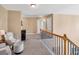 Upstairs hallway with natural light, neutral walls, and comfortable seating at 3285 Pebble Ridge Ln, Buford, GA 30519