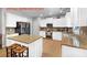 Bright kitchen featuring white cabinetry, granite countertops, stainless steel appliances, and a center island with barstool seating at 3285 Pebble Ridge Ln, Buford, GA 30519