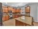 Open kitchen featuring wood cabinets, stainless steel appliances, granite countertops, and a center island with barstool seating at 3285 Pebble Ridge Ln, Buford, GA 30519