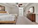 Bright main bedroom featuring neutral walls, a ceiling fan, and a cozy, carpeted floor at 3285 Pebble Ridge Ln, Buford, GA 30519