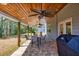 Covered patio featuring ceiling fans, stone pavers, and outdoor seating, perfect for entertaining guests at 3285 Pebble Ridge Ln, Buford, GA 30519