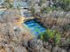 Aerial view of the neighborhood tennis courts surrounded by trees at 465 Hunt River Way, Suwanee, GA 30024
