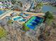 Aerial view of neighborhood amenities include tennis courts, pool, clubhouse and lake at 465 Hunt River Way, Suwanee, GA 30024