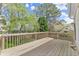 Spacious wooden deck surrounded by lush greenery, perfect for outdoor relaxation at 465 Hunt River Way, Suwanee, GA 30024