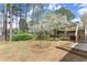 Spacious backyard with wooden deck, hot tub, and beautiful blossoming tree at 465 Hunt River Way, Suwanee, GA 30024