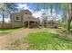 Inviting backyard with a wooden deck, hot tub, well-maintained lawn, and mature trees at 465 Hunt River Way, Suwanee, GA 30024