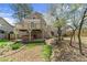 Two-story home's backyard features a wooden deck, hot tub, and mature trees at 465 Hunt River Way, Suwanee, GA 30024