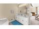 Bathroom with a double vanity, soaking tub, and view of the bedroom at 465 Hunt River Way, Suwanee, GA 30024