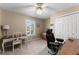 Functional bedroom with a desk, chair, closet, and neutral walls at 465 Hunt River Way, Suwanee, GA 30024