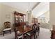 Formal dining room with elegant chandelier and wooden table perfect for entertaining at 465 Hunt River Way, Suwanee, GA 30024