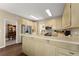 Bright kitchen featuring light wood cabinets, stainless steel appliances, and breakfast bar at 465 Hunt River Way, Suwanee, GA 30024
