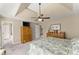 Bright primary bedroom with neutral walls, a ceiling fan, and traditional wooden furniture at 465 Hunt River Way, Suwanee, GA 30024