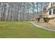 Beautiful backyard showcasing a large lawn area and a walkway leading to the side of the house at 155 Woodcreek Ln, Fayetteville, GA 30215
