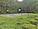 Recreational basketball court surrounded by trees and greenery at 155 Woodcreek Ln, Fayetteville, GA 30215