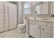Bathroom featuring gray walls, a tiled floor, a toilet, a cabinet, and a shower with a curtain at 155 Woodcreek Ln, Fayetteville, GA 30215