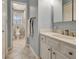 Ensuite bathroom with a tile floor, a white vanity, and a view of the toilet and shower at 155 Woodcreek Ln, Fayetteville, GA 30215