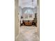 Luxurious bathroom showcasing a copper soaking tub, tiled floors, and a view through an arched window at 155 Woodcreek Ln, Fayetteville, GA 30215