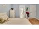 Bedroom featuring hardwood floors, light blue walls, and an ensuite bathroom at 155 Woodcreek Ln, Fayetteville, GA 30215