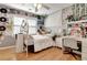 Cozy bedroom with hardwood floors, a ceiling fan, and decorated gray walls with a desk and chair set at 155 Woodcreek Ln, Fayetteville, GA 30215