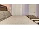 Close up on the bed in the bedroom featuring light lavender walls and a closet at 155 Woodcreek Ln, Fayetteville, GA 30215