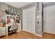 Bedroom featuring hardwood floors, a neutral color scheme, decorated walls, double closets and a door at 155 Woodcreek Ln, Fayetteville, GA 30215