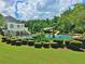 Community pool area, with a slide, umbrellas, and lounge chairs at 155 Woodcreek Ln, Fayetteville, GA 30215