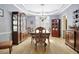 Formal dining room with hardwood floors, chandelier, and ample seating at 155 Woodcreek Ln, Fayetteville, GA 30215