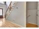 Entryway with hardwood floors, stairs with wooden railing, and natural light from the front door at 155 Woodcreek Ln, Fayetteville, GA 30215