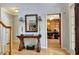 Foyer with hardwood floors, elegant console table, and view into the home office at 155 Woodcreek Ln, Fayetteville, GA 30215