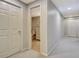 Hallway with neutral walls, carpet, and doors, and a view of a bathroom with white furniture at 155 Woodcreek Ln, Fayetteville, GA 30215