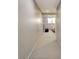 Hallway with neutral walls and carpet, with a view into a living room with couch and black coffee table at 155 Woodcreek Ln, Fayetteville, GA 30215