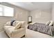 Living room with carpet, neutral walls, a window, a white couch and a queen bed covered in gray linens at 155 Woodcreek Ln, Fayetteville, GA 30215